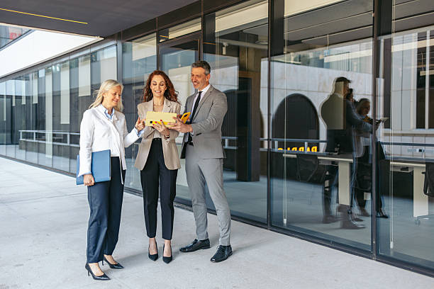 istock Businesspeople reviewing contract terms outside modern office building 2216036066