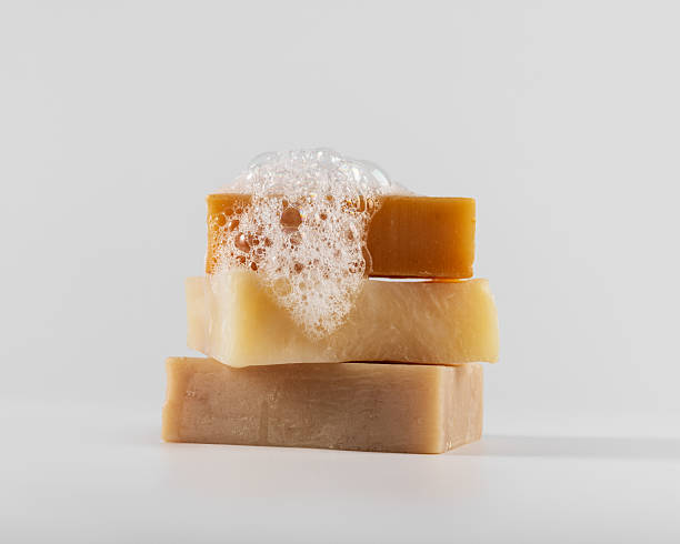 istock Stack of three handmade natural soap bars with foam and bubbles on a white background 2216037583