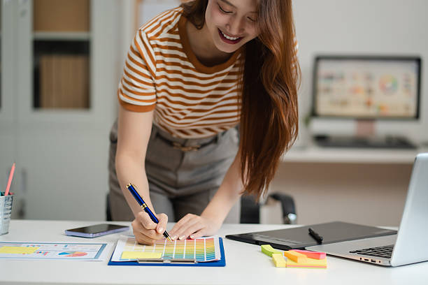 istock Designer woman thinking ideas strategy about mobile app interface wireframe design with customer breif and color code, User experience concept. 2216037671