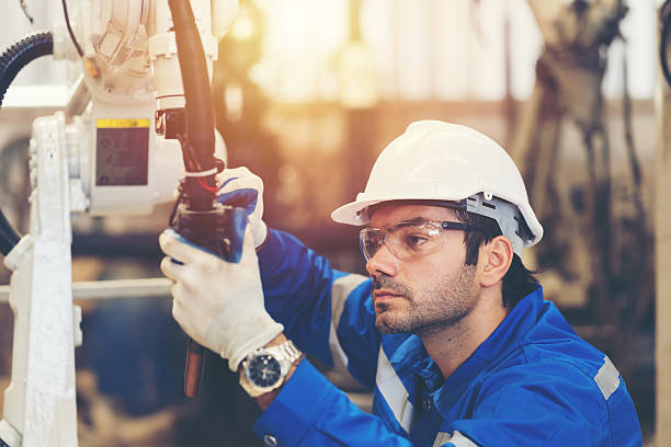 istock Male engineer worker repair automatic robotic arm in factory. Male technician worker inspecting quality automatic welding robot arm machine at production line 2216042950