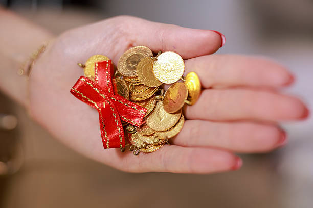 istock Woman hand holding 1/4 turkish gold 2216043811