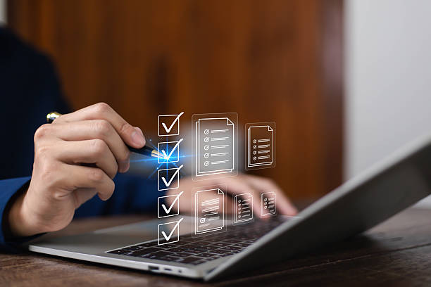 istock Businessman working on computer using laptop. Concept of business performance tracking and evaluation. Document management system DMS. Performance checklist evaluation form. 2216044198