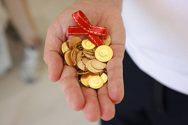 istock Man hand holding 1/4 turkish gold 2216046161