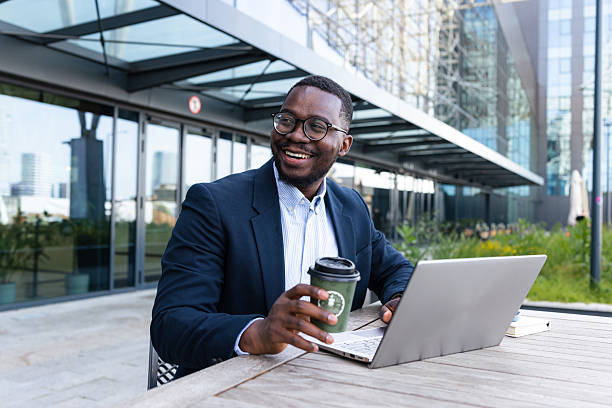 istock Businessmen enjoying coffee while working on a laptop outdoors 2216048729