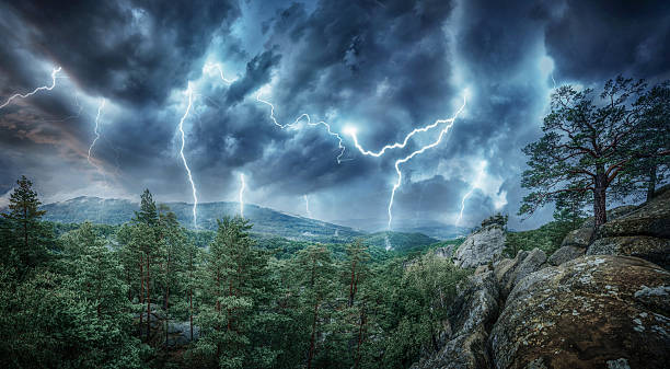 istock Lightning thunderstorm flash in the mountains and forest. Concept on topic weather, cataclysms (hurricane, Typhoon, tornado, storm) 2216049560