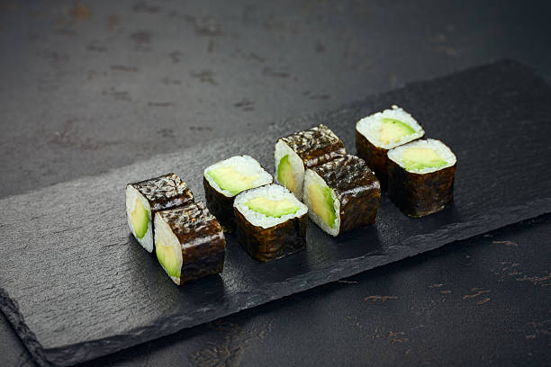 istock Roll with avocado on dark background. Sushi menu. Japanese food. 2216053753