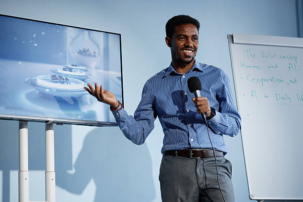 istock Smiling Black Man Speaking on AI Technologies at Business Conference 2216054693