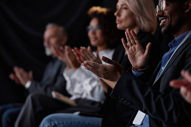 istock Smiling Black Man Applauding Speech at Business Conference in Auditorium 2216054723