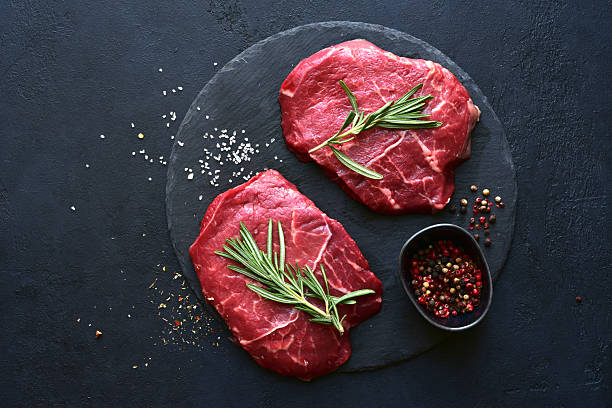 istock Raw organic marbled beef steak with ingredients for cooking . Top view with copy space. 2216055476
