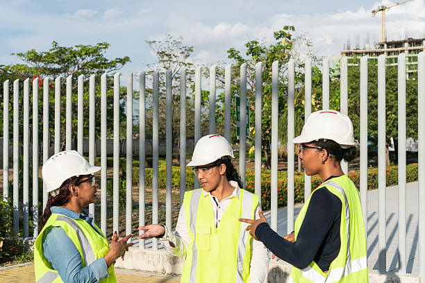 istock Female construction workers discussing a project near a construction site 2216056673
