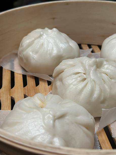 istock Simple but delicious: fresh steamed buns in bamboo steamer 2216057598