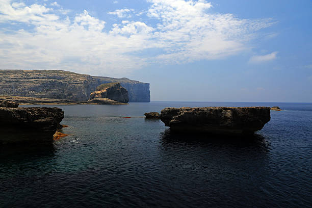 Natural limestone rock window overlooking the Mediterranean Sea on the rugged coast of Gozo Malta.