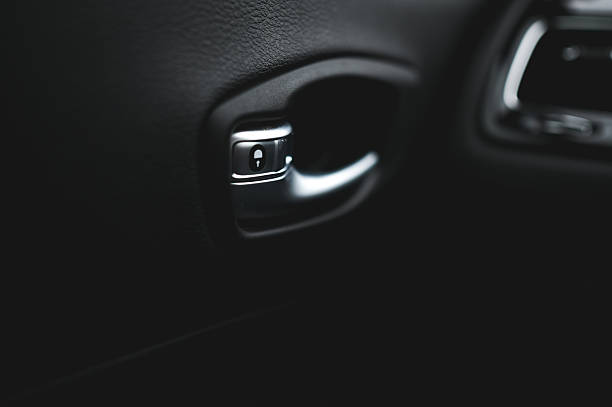 Close-up of car door handle with lock button in modern vehicle
