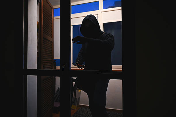 istock Masked burglar breaking into a house at night 2216057753