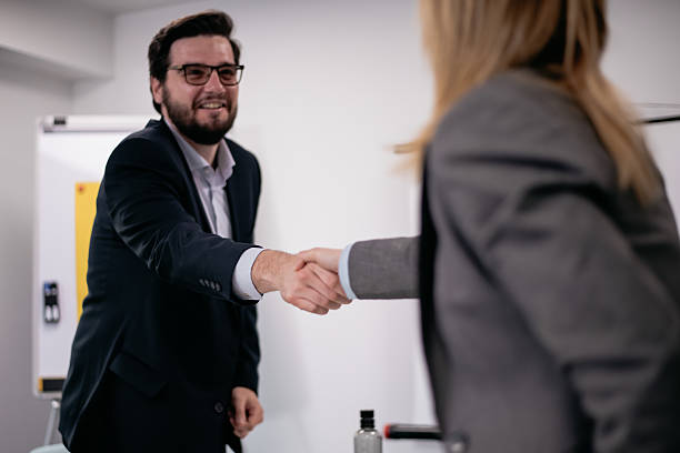 istock Business professionals shaking hands during a formal meeting in a modern office space 2216058530