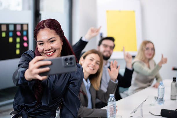 istock Group of colleagues capturing a selfie during a vibrant meeting in a modern office 2216058564