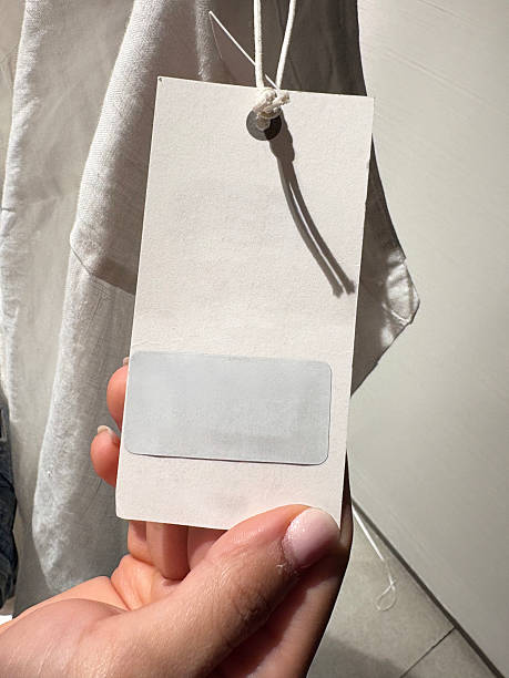 Hand Holding White Price Tag