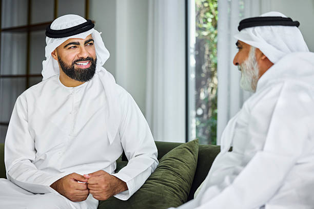istock Arab male in traditional attire talking with man 2216062532