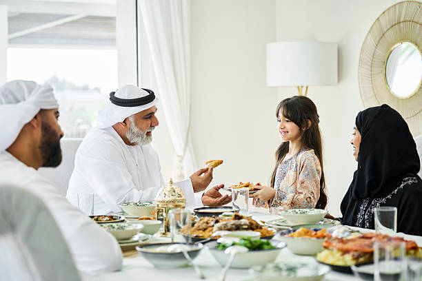 istock Grandfather picking up fried snack from plate 2216062689