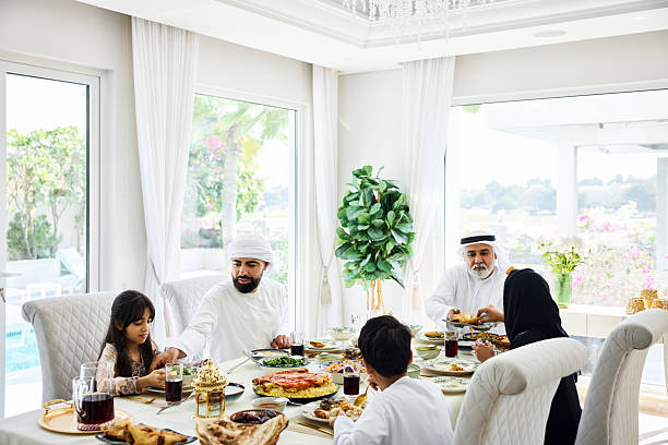 istock Emirati family having dinner at dining table 2216062696
