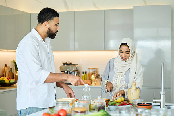 istock Husband helping his wife cutting vegetables 2216062781