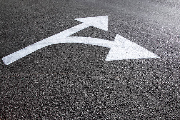 istock white directional arrows marked on the asphalt 2216065692
