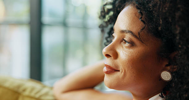 istock Thinking, smile and woman relaxing in home on weekend with memory, self reflection or daydreaming. Happy, calm and female person with decision, choice or peaceful morning on sofa in apartment. 2216065836