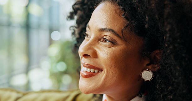 istock Thinking, happy and woman relaxing in home on weekend with memory, self reflection or daydreaming. Smile, calm and female person with decision, choice or peaceful morning on sofa in apartment. 2216065838