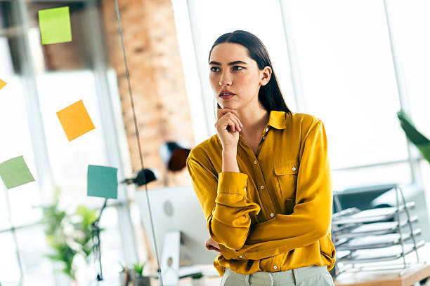 istock Thoughtful businesswoman planning ideas in a modern office environment with bright daylight and stylish interior decor elements 2216066048