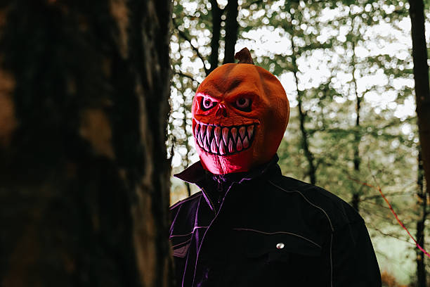 istock Scary Pumpkin Head Mask in Forest 2216067187