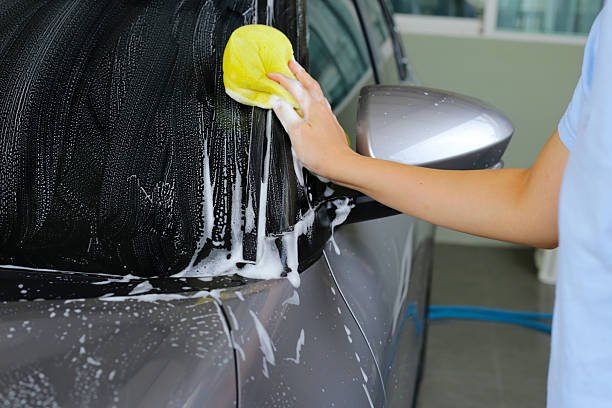 istock Washing car with yellow sponge 2216067804
