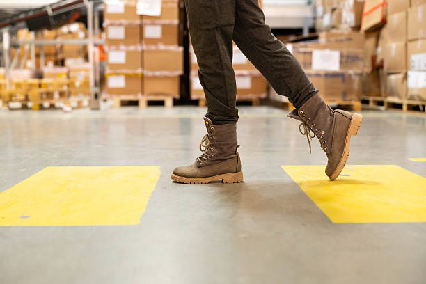 istock Female Worker Walking in Warehouse on marked walkway 2216068883