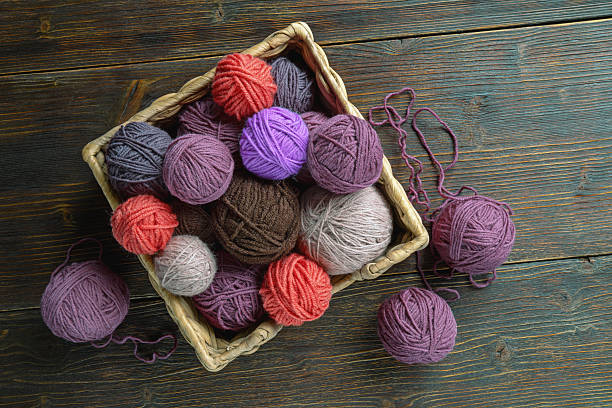 istock Multicolored balls of wool on dark rustic table. Knitting and hobby concepts. Copy space 2216071919