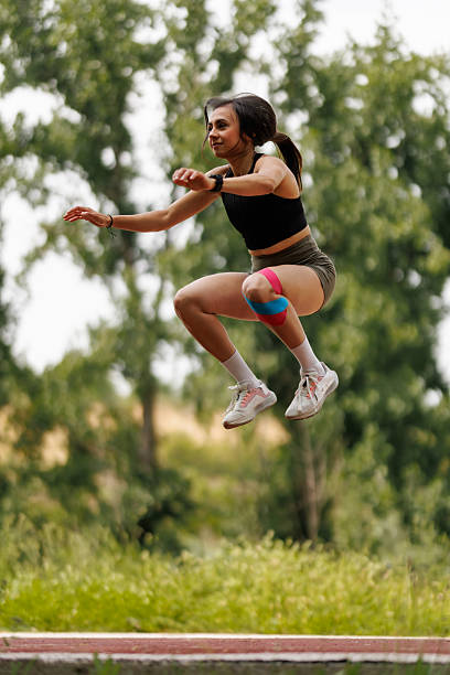 istock Athletic Woman Performing a Jump Exercise Outdoors in Nature 2216072289