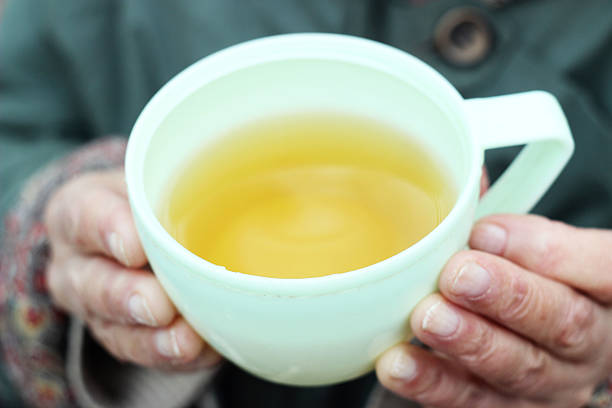 Elderly women sharing a moment with family, drinking traditional yerba mate in a warm home setting
