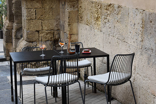 istock Street restaurant table, empty cafe table, outdoor restaurant, summer street table. Empty table with empty glasses after an aperitif in Italy, Sicily, Noto. 2216074658