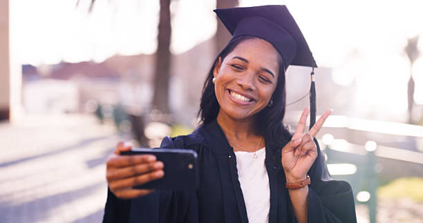 istock Happy Graduate Taking a Selfie While Celebrating Academic Achievement Outdoors 2216077608