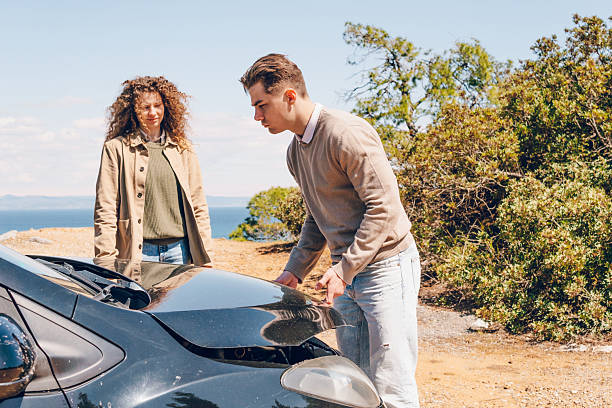 istock A young couple have a problem with a car, man calling car service 2216077703