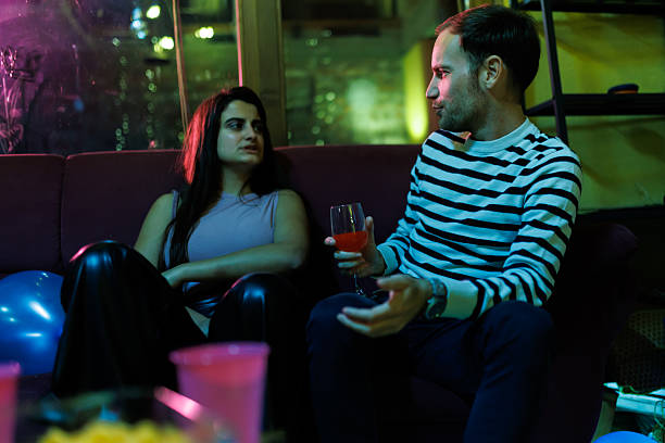 istock Two friends discussing over drinks in a relaxed evening setting indoors 2216078782