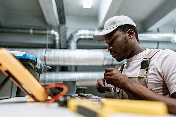 istock Skilled technician working on electrical equipment in a modern industrial workshop during daytime hours 2216078893
