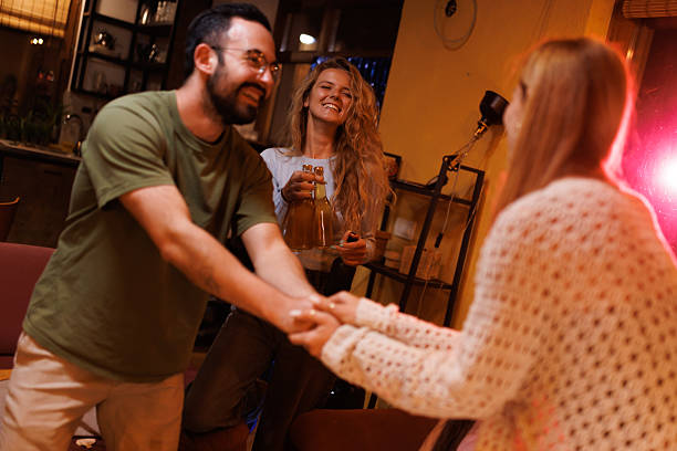 istock Friends enjoying a cozy indoor gathering with laughter and joy 2216079618