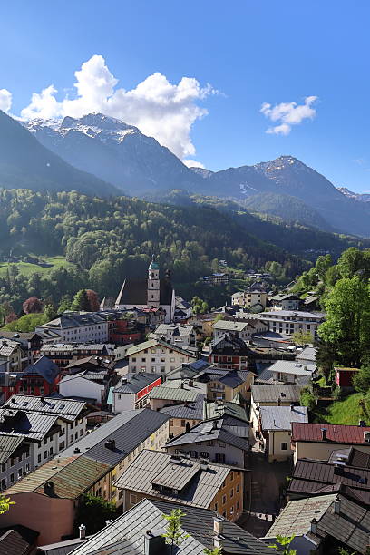 istock Berchtesgaden rooftops and church with mountains in spring, Bavaria, Germany. 2216079820