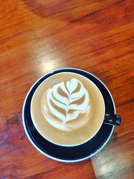 Layered and feathery latte art design in the coffee creamy foam