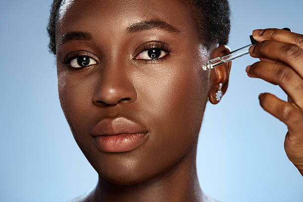 istock Skincare routine with serum application by a woman in a studio setting 2216080365