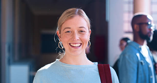 istock Cheerful Student Posing in a Busy Hallway at an Educational Institution 2216080496