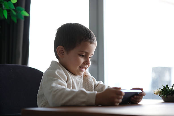 istock little boy is happy watching social media 2216083923