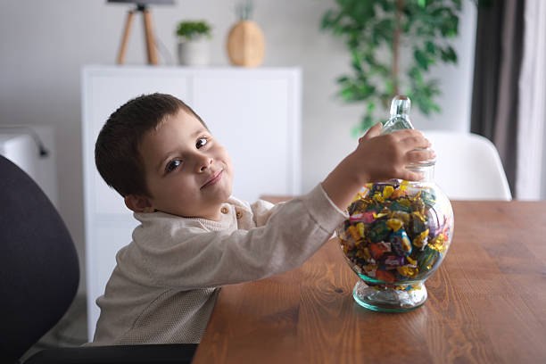 istock Sweet boy holding a jar full of candy 2216083993