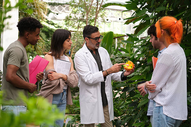istock Biology teacher explaining plant cell structure to students in greenhouse 2216084814