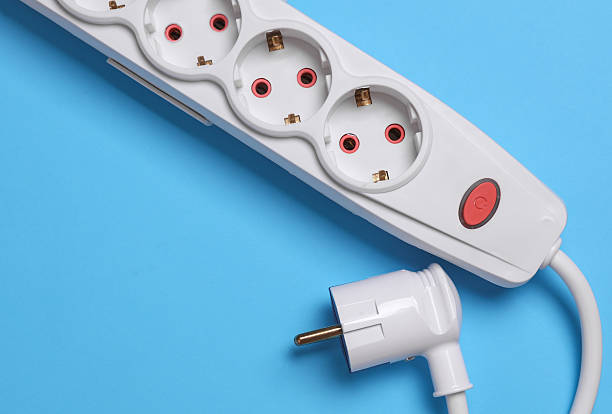 istock White electric extension cord with power button and plug  on blue background 2216085307