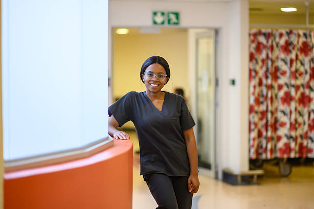 istock Smiling young medical student standing confidently in hospital corridor 2216090533